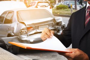 Insurance Adjuster examining a total loss vehicle