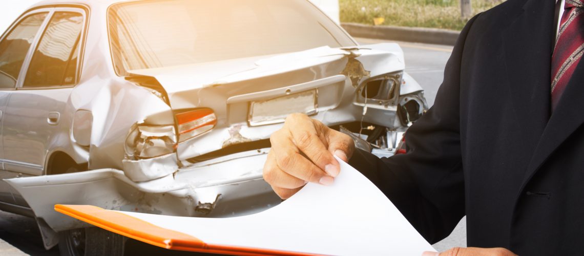 Insurance Adjuster examining a total loss vehicle