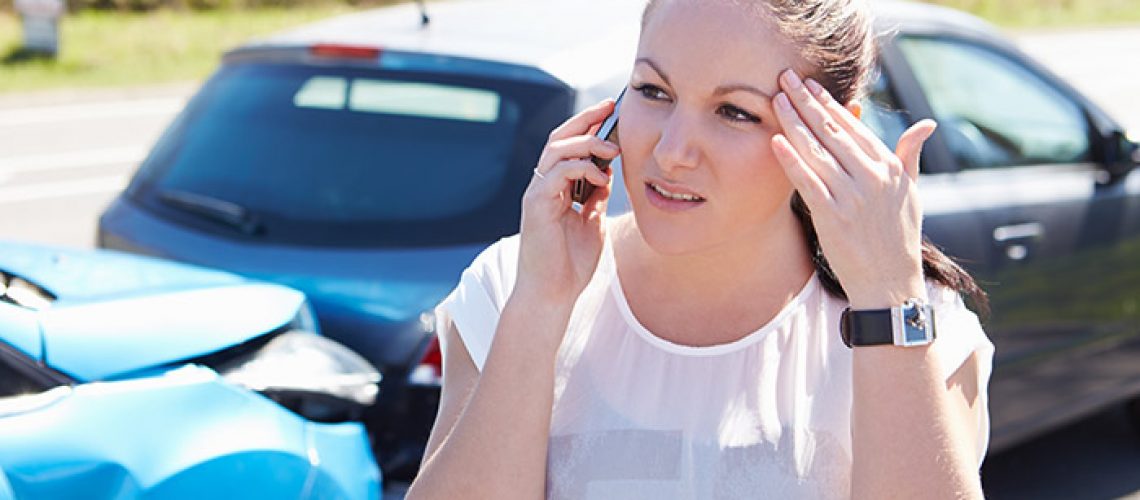 Female Driver Making Phone Call After an Accident